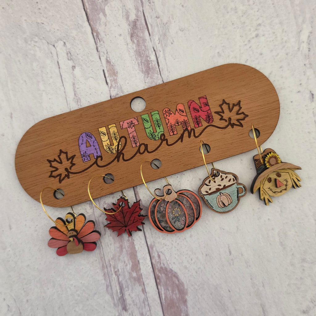 Set of five autumn wine charms with decorative wooden holder