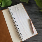 Open leatherette tally book cover showing interior notebook pocket