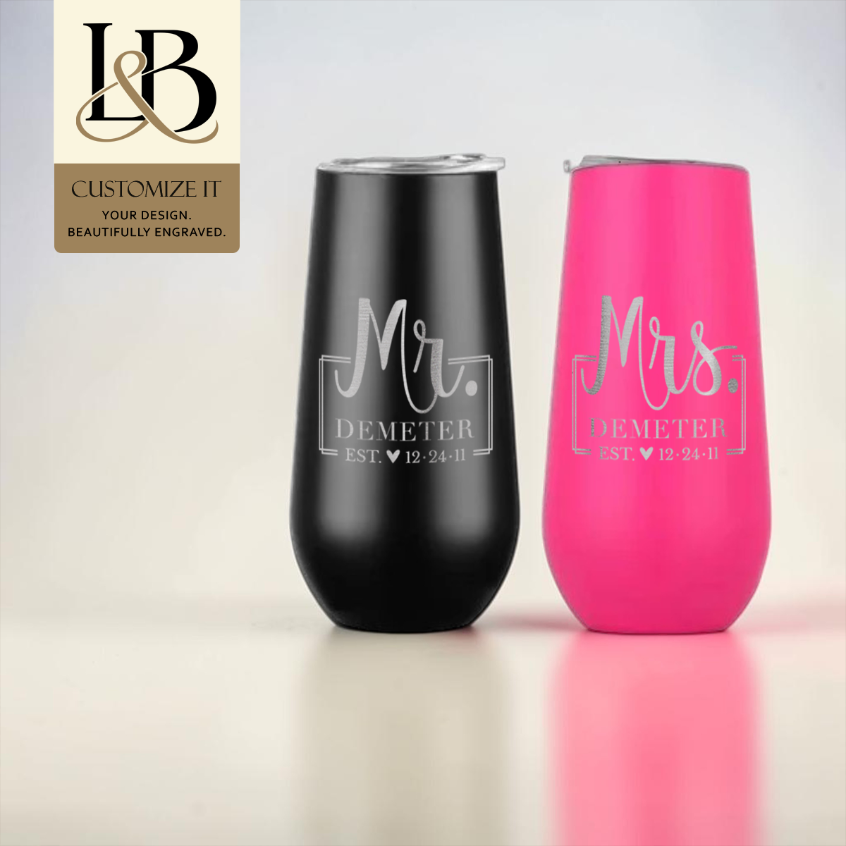 Black Mr. and pink Mrs. personalized stemless flutes with a gold brand badge against a pale background.