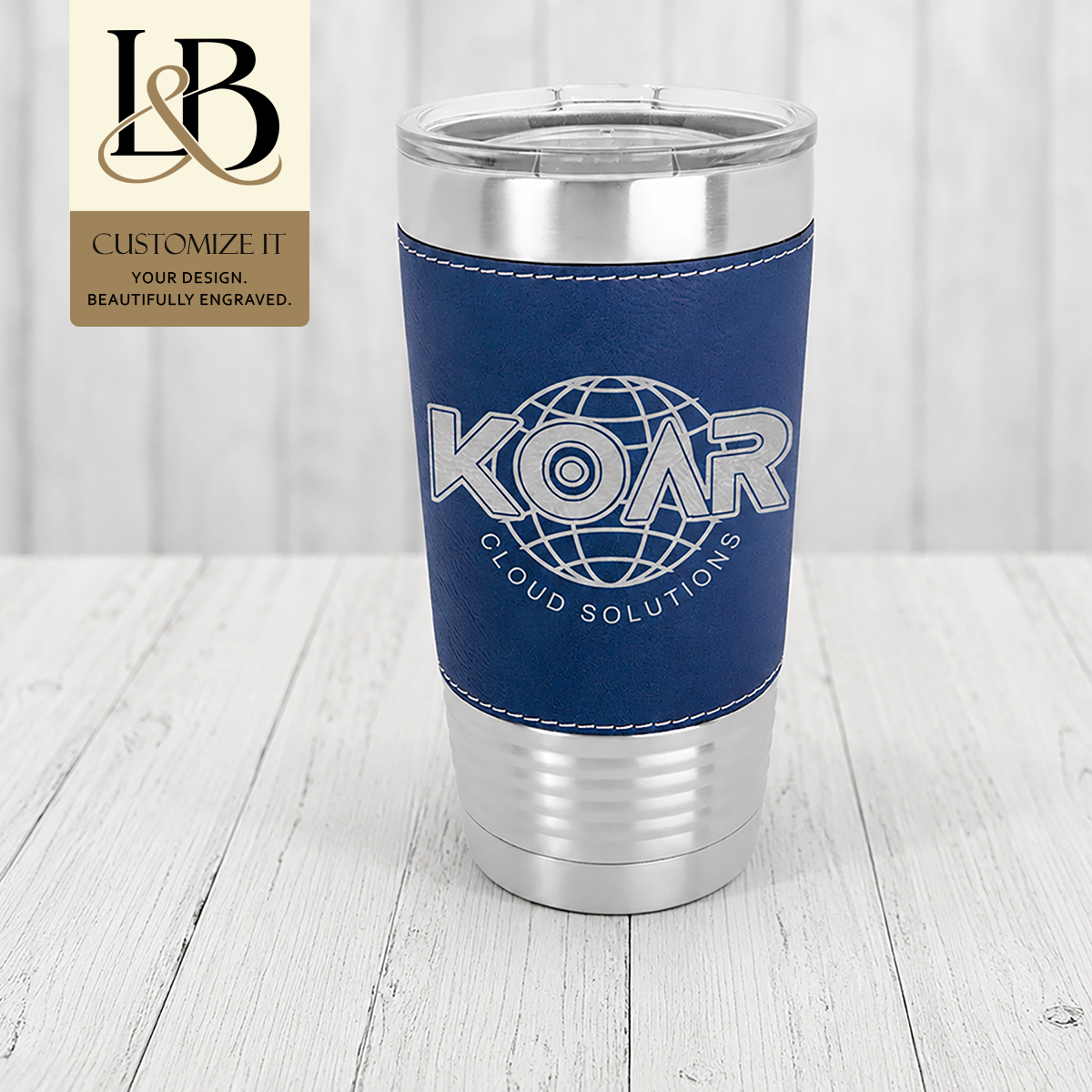 Blue KOAR stitched-wrap travel tumbler with a ribbed silver base and gold brand badge.