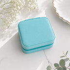 Compact personalized jewelry case with soft suede interior for travel in aqua