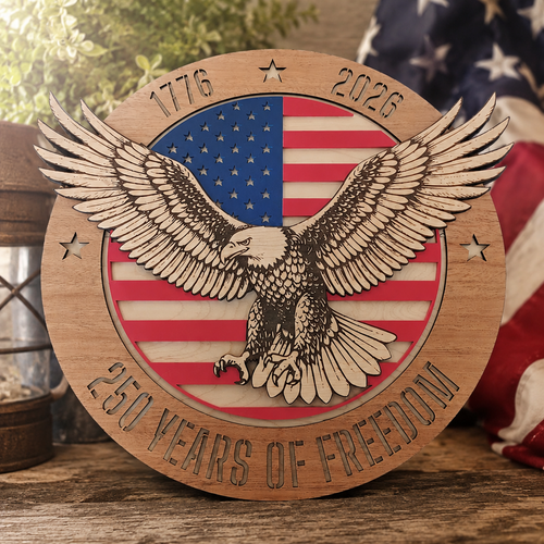 Layered eagle and American flag plaque marked 250 Years of Freedom beside a folded American flag.
