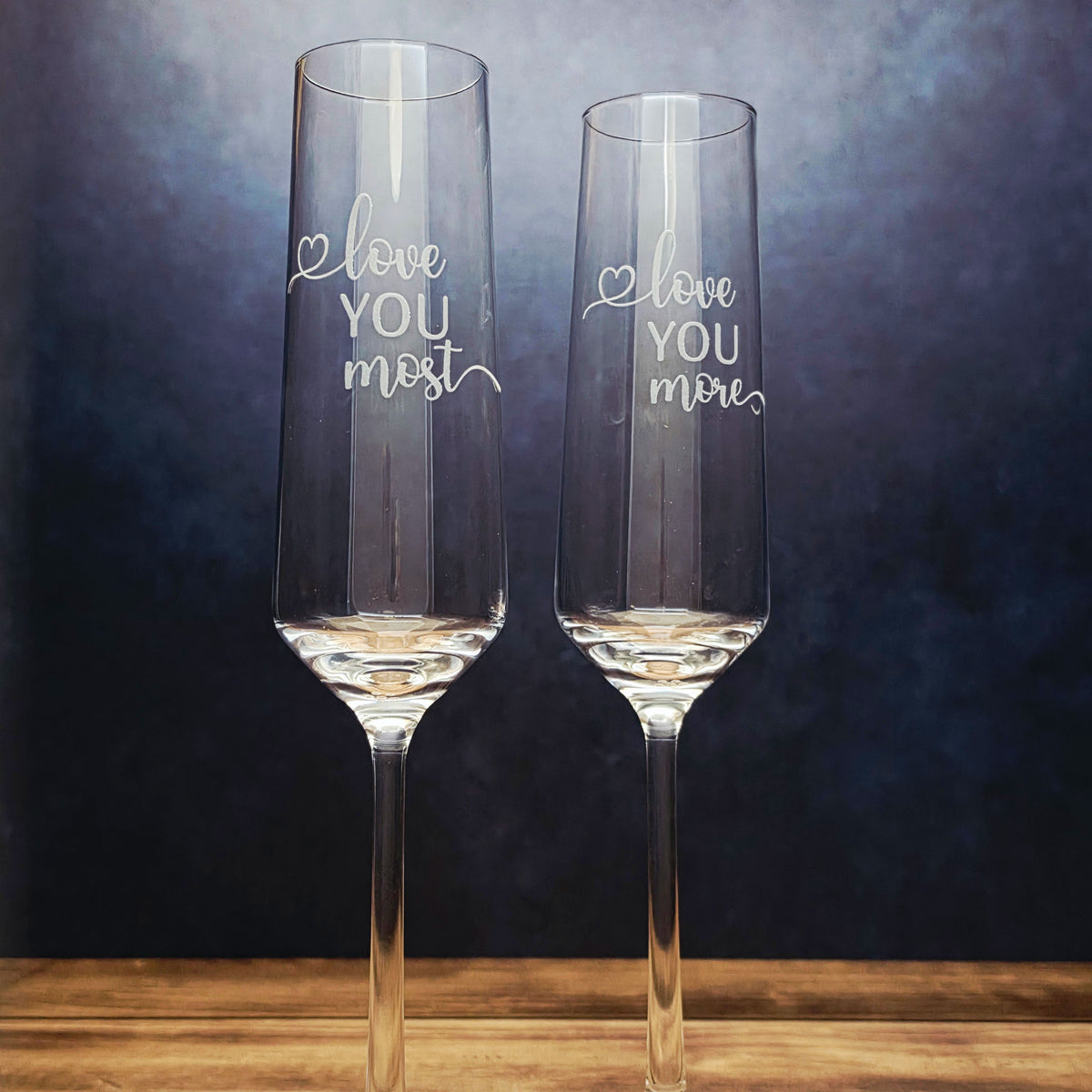 Set of two Love You More Love You Most engraved champagne flutes