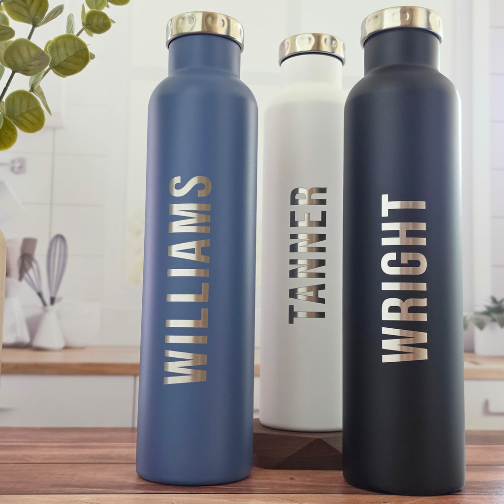 Two personalized stainless steel wine growlers with custom laser-engraved designs