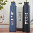 Two personalized stainless steel wine growlers with custom laser-engraved designs
