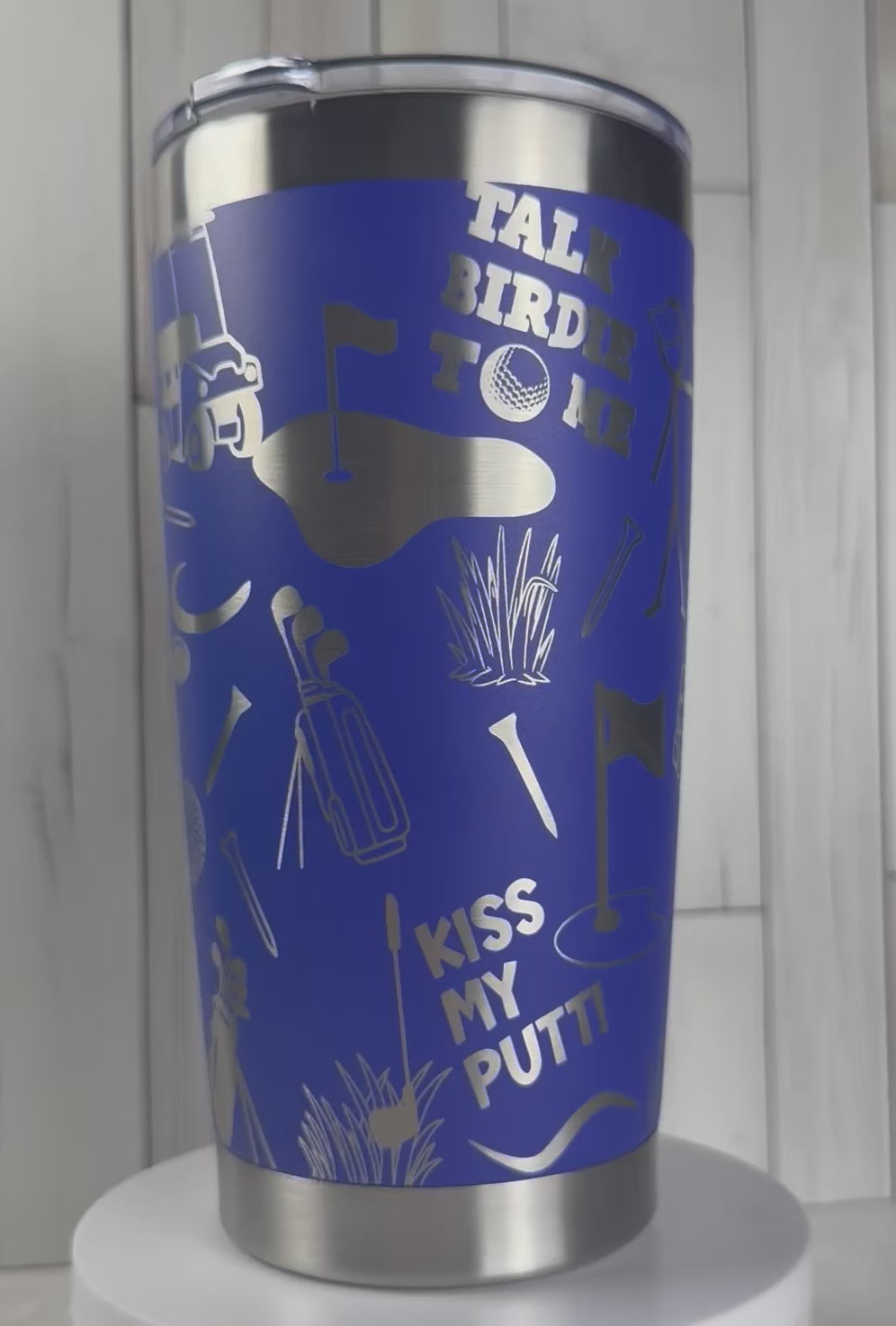 Blue tumbler with an engraved golf theme design.